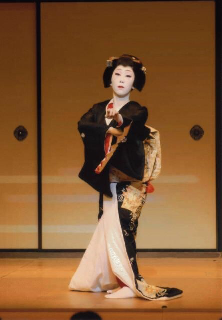 白い裾を引いて立つ『黒髪』の舞台写真
